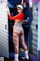 A woman in a baseball uniform standing in a locker.