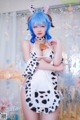 A woman in a cow costume posing for a picture.