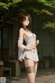 Anime girl in a white dress and stockings posing for a picture.